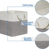A set of four fabric storage cubes with soft lining, convenient handles, and a durable material in gray and white.