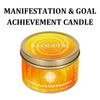 A jar of Manifestation & Goal Achievement candle with an Evoduck label and orange-yellow wax.