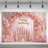 A pink and gold balloon arch backdrop featuring a castle facade for a birthday party.