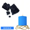 Moon blue candle in a gold wire holder with dark dye blocks nearby