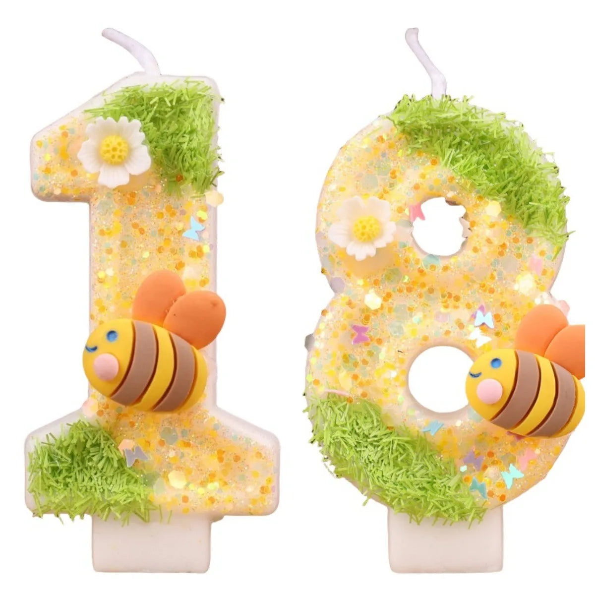 A yellow birthday candle shaped like the number 1 and 8 decorated with flowers and green moss.