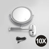 A round, illuminated double-sided magnifying makeup mirror with a metal handle and USB charging cable.