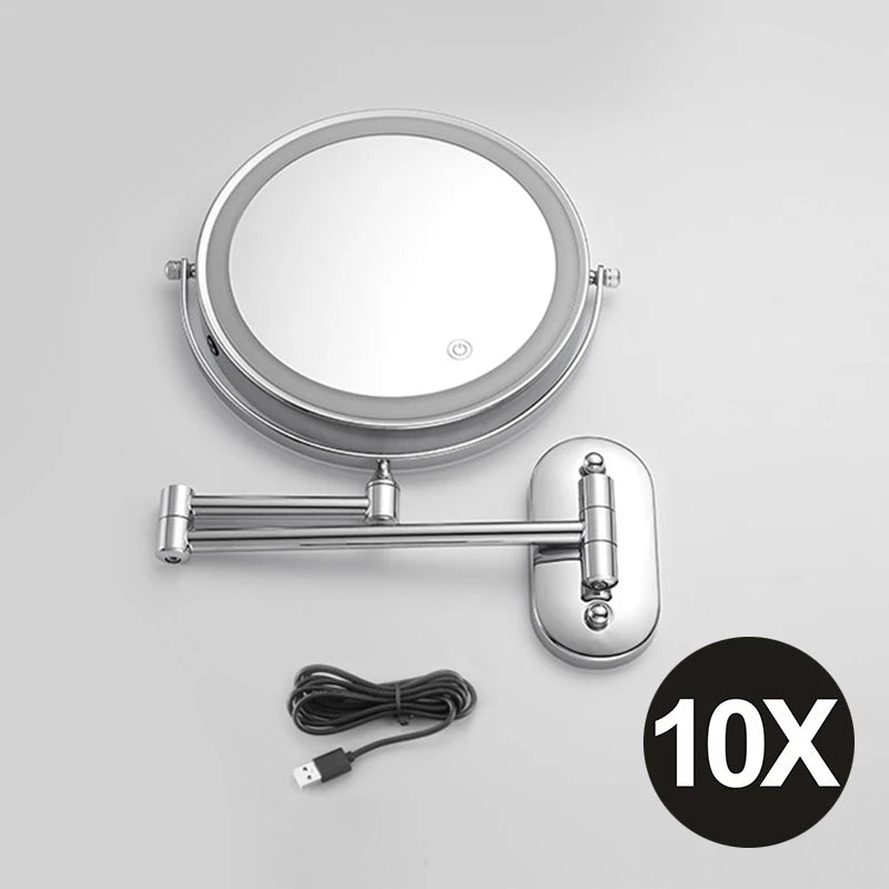 A round, illuminated double-sided magnifying makeup mirror with a metal handle and USB charging cable.