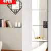 Four self-adhesive acrylic mirror tiles used as decorative wall stickers in a modern bathroom or bedroom setting.