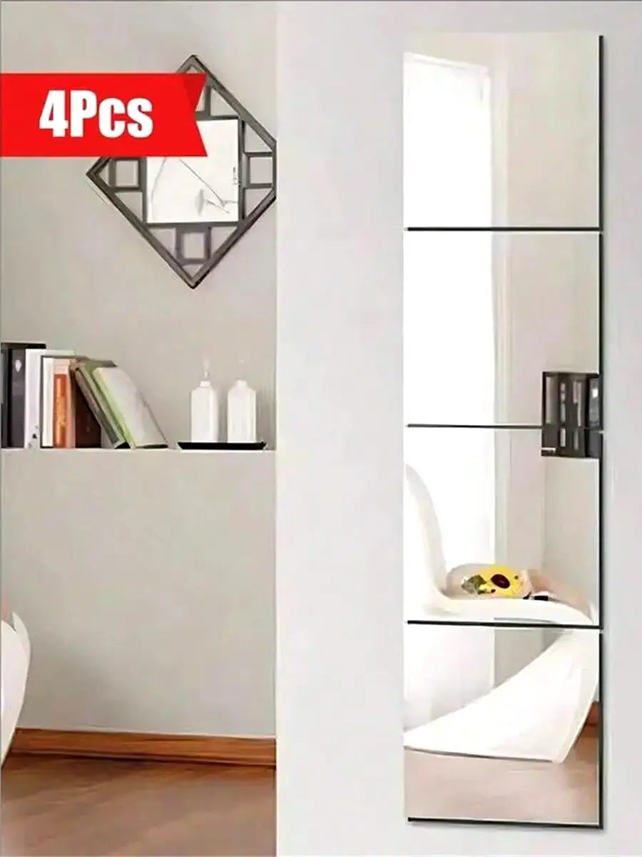 Four self-adhesive acrylic mirror tiles used as decorative wall stickers in a modern bathroom or bedroom setting.