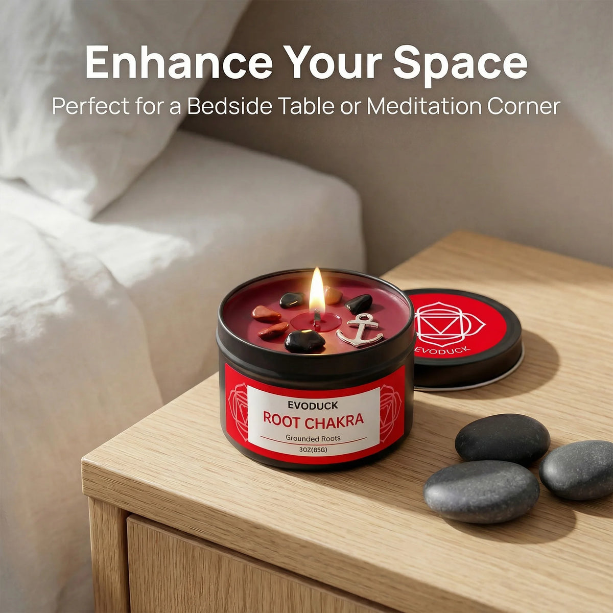 A red candle jar labeled Evoduck Root Chakra with a flame and several dark stones on a wooden surface.