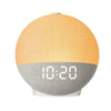 A round alarm clock with an orange top and a gray base displaying the time 10:20