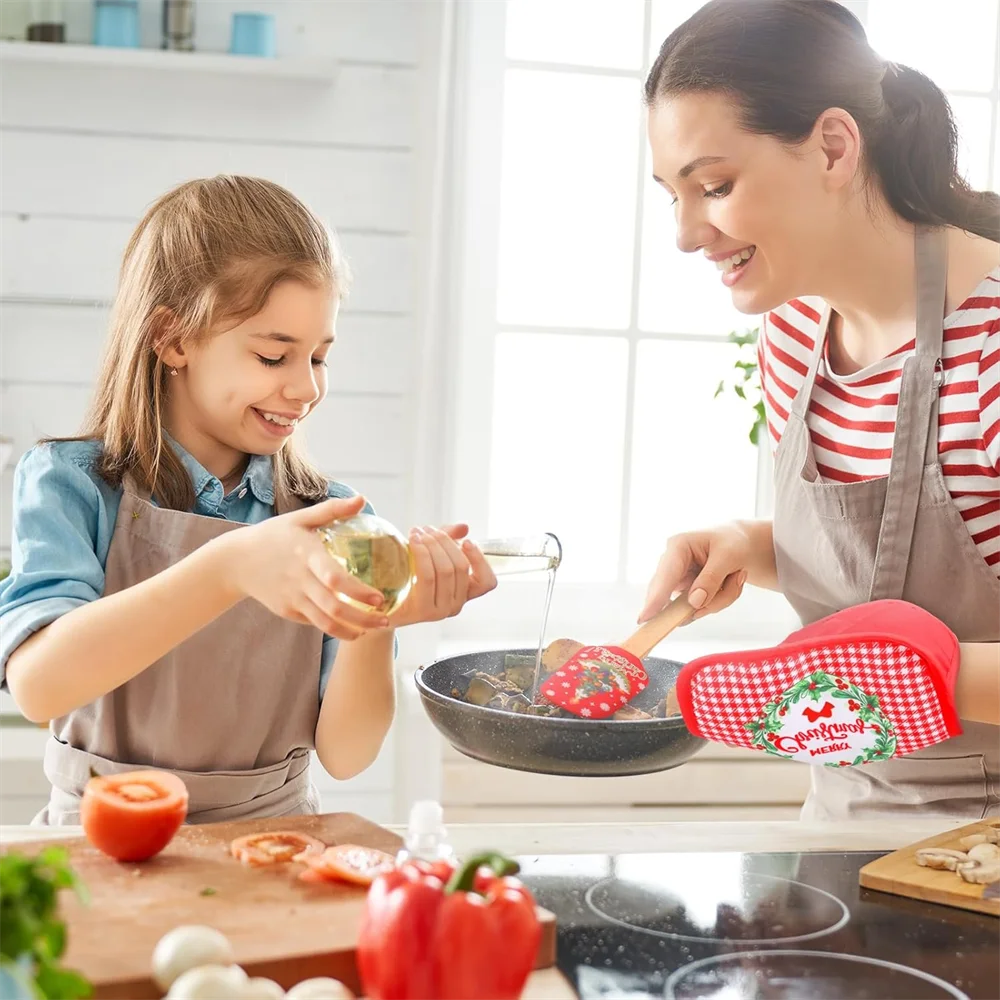 A woman and a girl are baking together using a festive Christmas silicone spatula with a wooden handle.