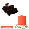 A single bright orange candle in a gold holder, next to dark chocolate dye blocks.