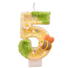 A golden number five candle decorated with green moss and an orange bee.