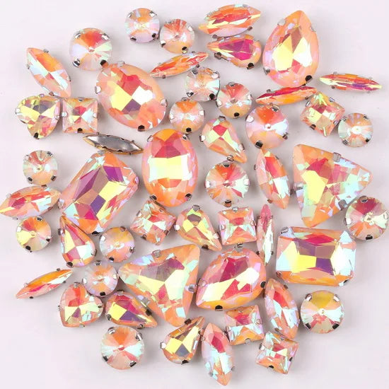 A mix of iridescent glass rhinestones in jelly candy AB colors, shaped like claws and various facets.