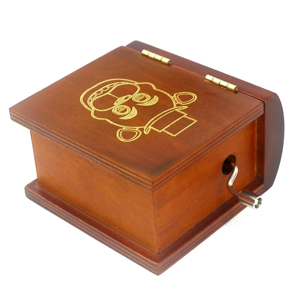 A classic wooden hand-crank music box with carved details, featuring a warm brown finish and brass accents.