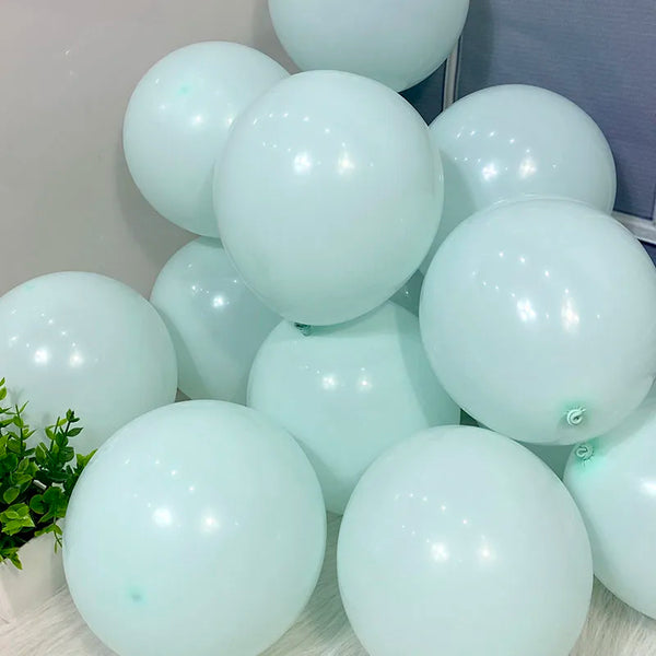 A collection of light mint green pastel candy balloons clustered together.