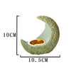 A light green antique crescent resin incense burner with a gold-colored textured finish.