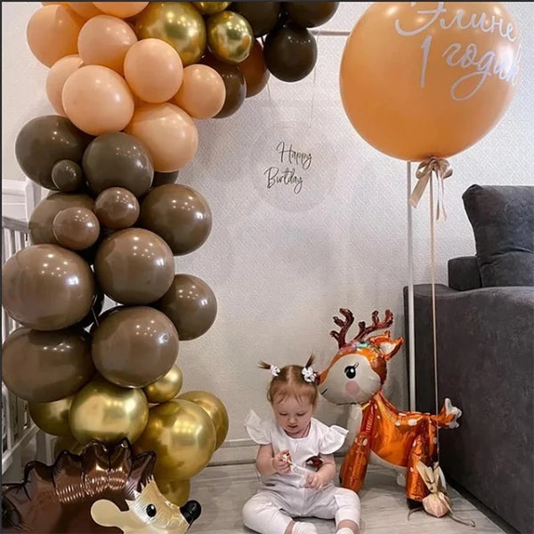 A set of woodland animal foil balloons including a deer and other animals for a birthday party decoration.