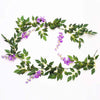 A green silk wisteria garland vine with purple flowers used for weddings and home decor.