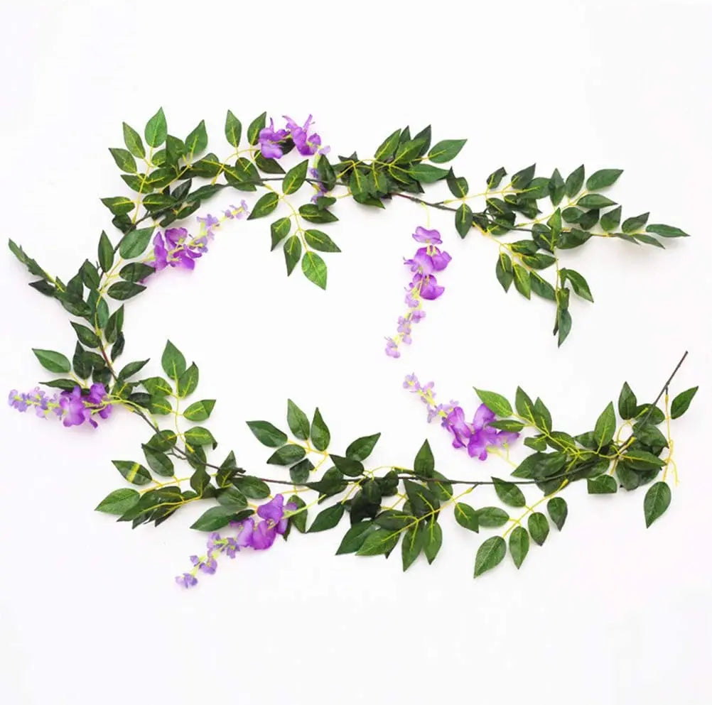 A green silk wisteria garland vine with purple flowers used for weddings and home decor.