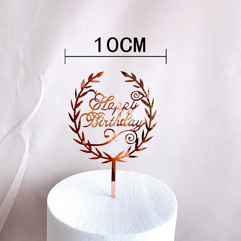 Rose gold acrylic happy birthday wreath cake topper on a white pedestal