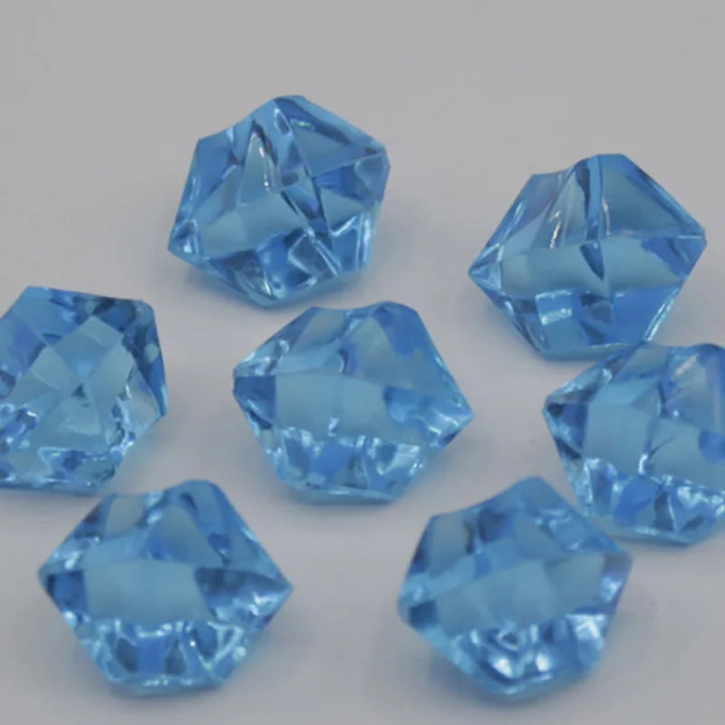 A collection of light blue acrylic crystal decorations shaped like pyramids and facets.