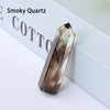 A smoky quartz point prism crystal specimen resting on a white surface.