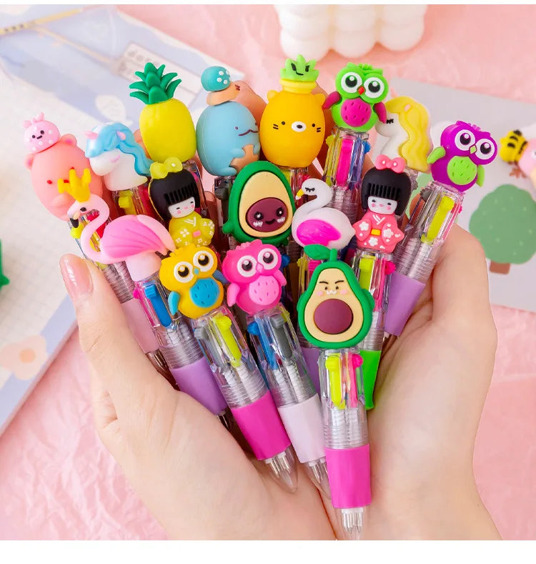 A hand holds a set of five cute cartoon mini ballpoint pens featuring various colorful characters and designs.
