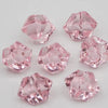 Pink acrylic crystal decorations shaped like facets and geometric solids for parties
