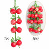 A vertical arrangement of five bright red artificial fruits or vegetables on a green stem.