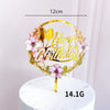 Rose gold acrylic happy birthday cake topper featuring floral accents on a white cake.