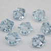 A collection of clear blue acrylic crystal decorations shaped like pyramids and facets for parties