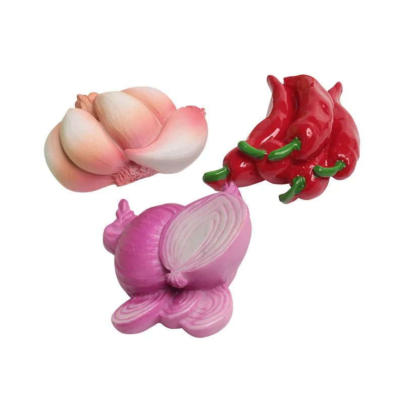 A set of three realistic fruit and vegetable fridge magnets in pink, red, and purple tones.
