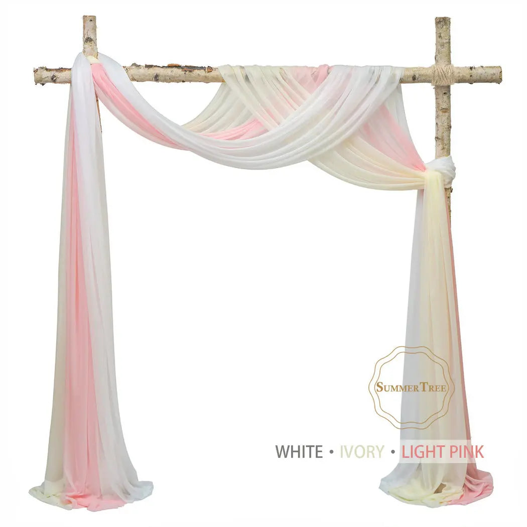 Sheer chiffon fabric drape in white, ivory, and light pink colors suspended on a wooden cross for weddings and events