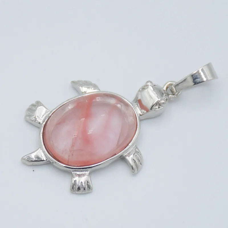 Silver pendant necklace featuring a polished pink and white agate stone shaped like an animal.