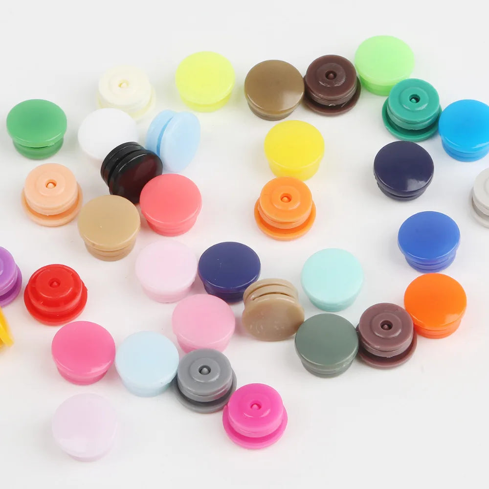 Assorted snap buttons in various colors including green, yellow, purple, pink, and brown for crafting