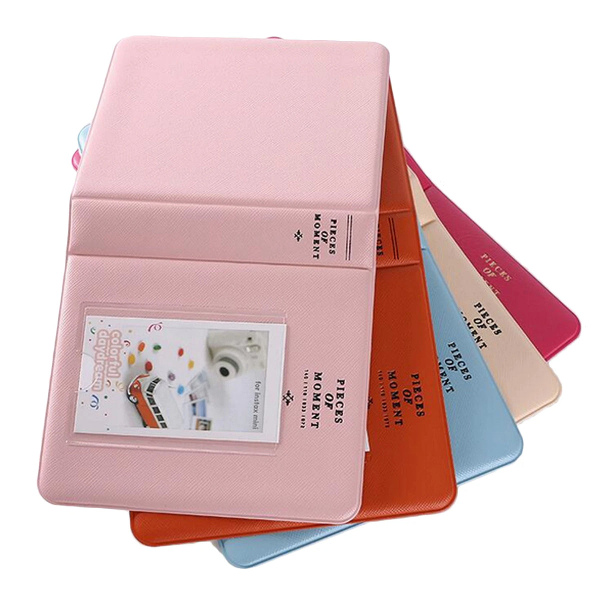 A stack of pink and orange compact photo albums for instant film.