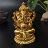 Gold Ganesha statue handcrafted resin figurine with a crown and ornate details.