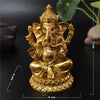 Gold Ganesha statue handcrafted resin figurine with a crown and ornate details.