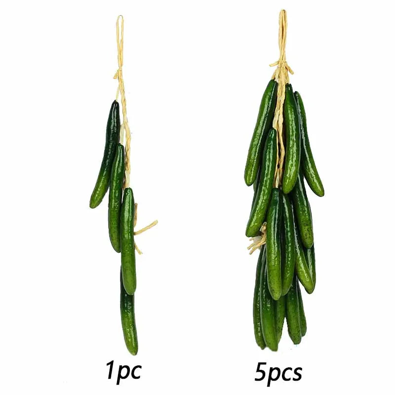 A bundle of five artificial green eggplants hanging from twine.
