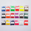 A collection of brightly colored, fine powder dye colorants in small plastic bags for DIY wax projects.