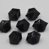 A collection of black acrylic crystal decorations shaped like pyramids or tetrahedrons.
