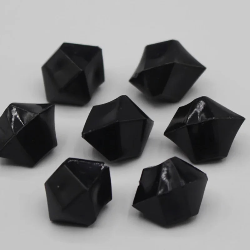 A collection of black acrylic crystal decorations shaped like pyramids or tetrahedrons.