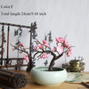 Artificial silk cherry blossom branches on a ceramic pot for home and wedding decor