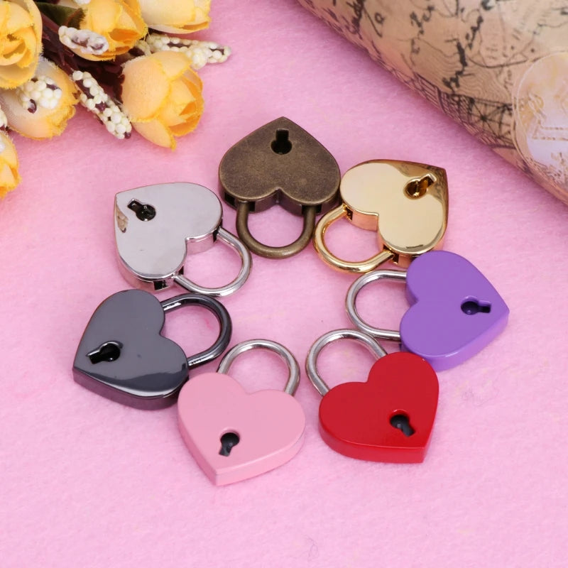 A collection of vintage heart-shaped mini padlocks in various colors including gold silver purple and red