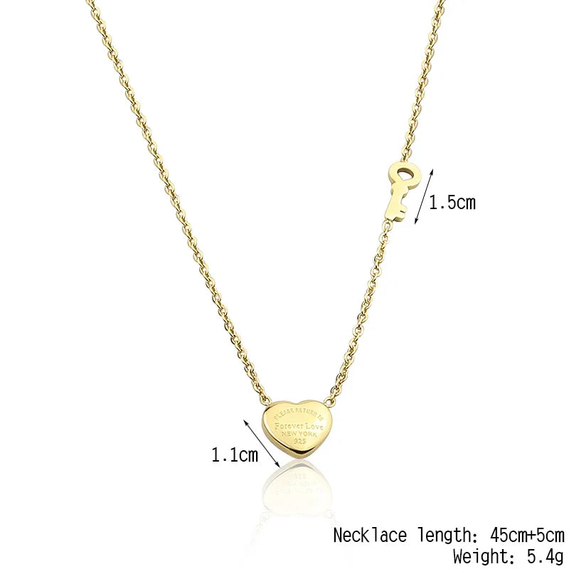Gold-tone titanium steel heart lock key pendant necklace with a chain and a heart charm