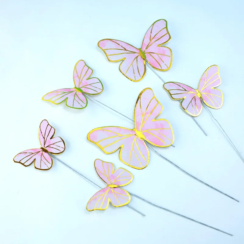 Pink and gold butterfly cake toppers on thin sticks for parties and baking