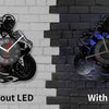 A comparison of a motorcycle rider vinyl record wall clock without LED and with LED versions mounted on a brick wall.