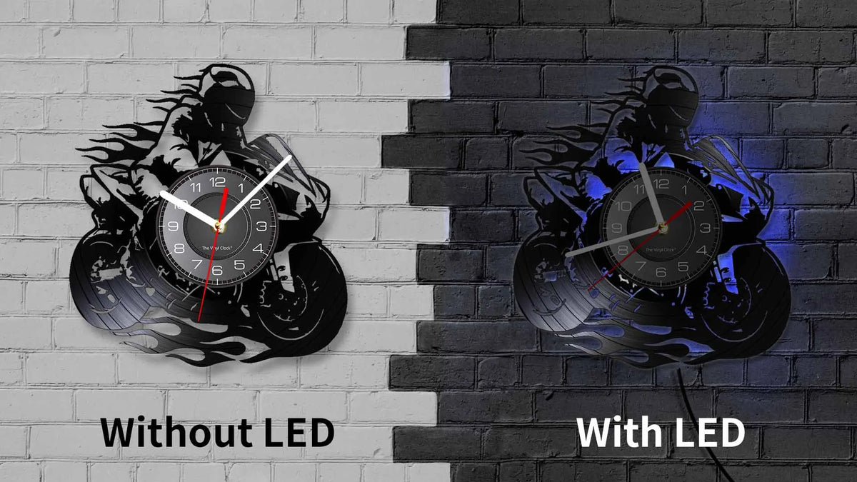 A comparison of a motorcycle rider vinyl record wall clock without LED and with LED versions mounted on a brick wall.