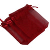 A stack of deep red organza drawstring gift pouches for jewelry, candy, or party favors.