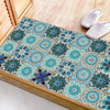 A rectangular tile featuring intricate blue and teal mandala patterns, displayed next to a pair of beige slippers.