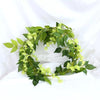 Green silk wisteria garland vine with light green flowers used for weddings and home decor