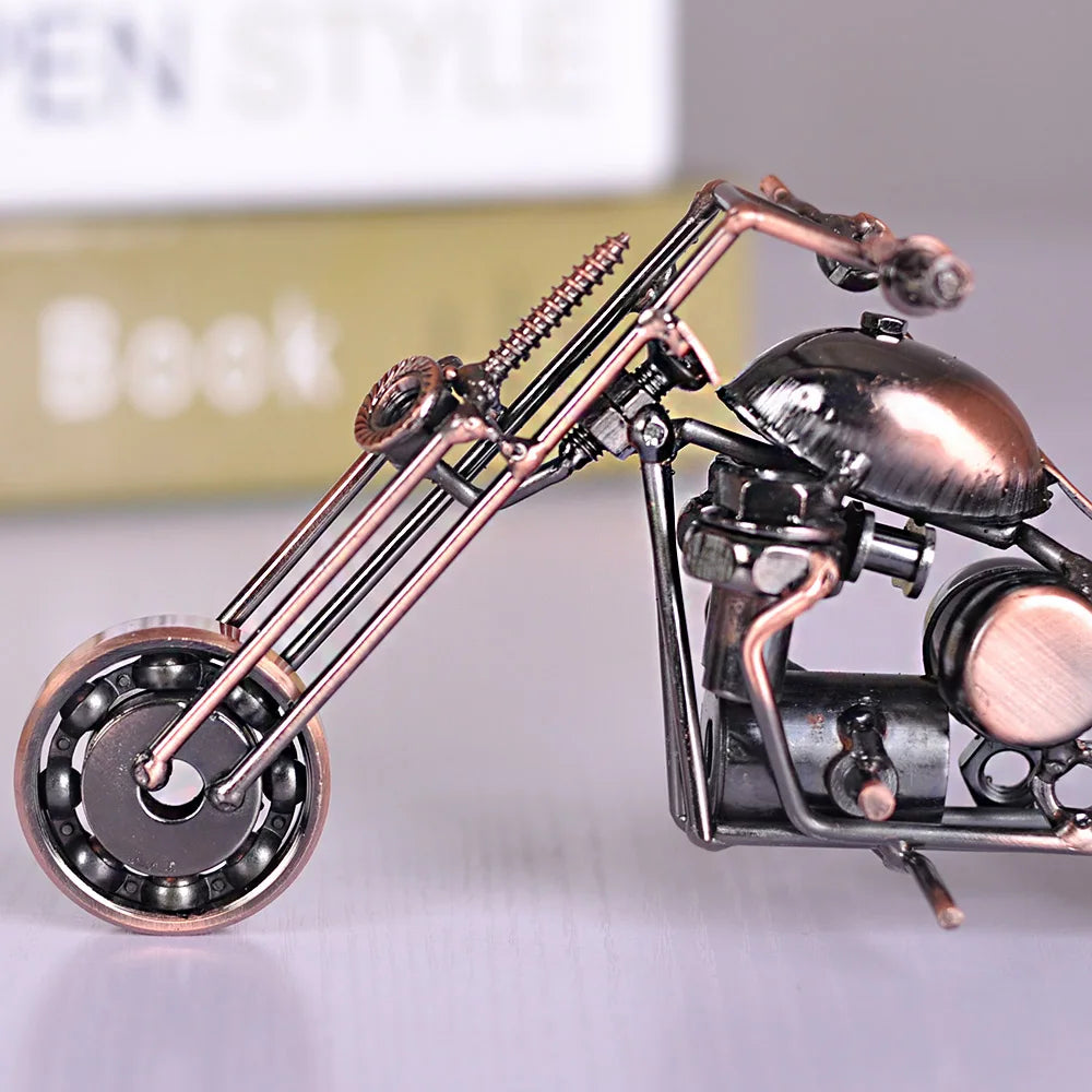 A handcrafted metal motorcycle model with a vintage aesthetic, featuring copper and dark metal components.